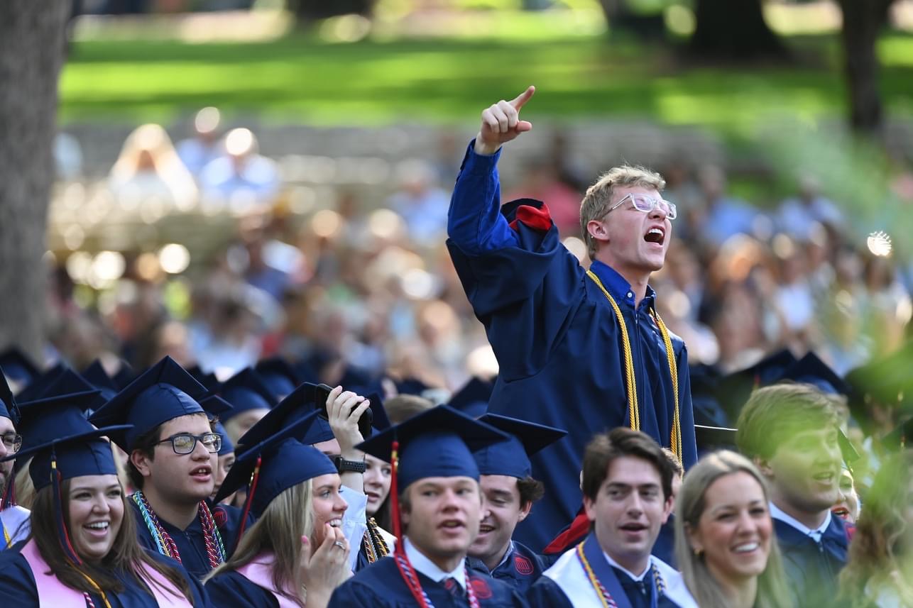 Group of graduates at commencement with one leading Hotty Toddy